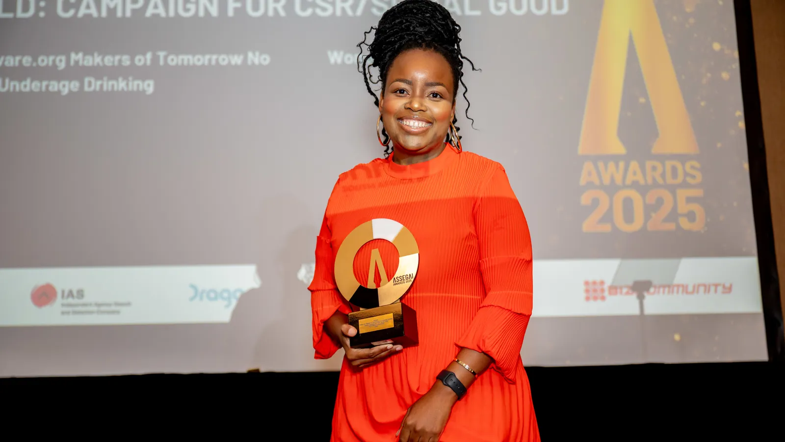 Assegai Awards 2025 category winner posing with her trophy on stage