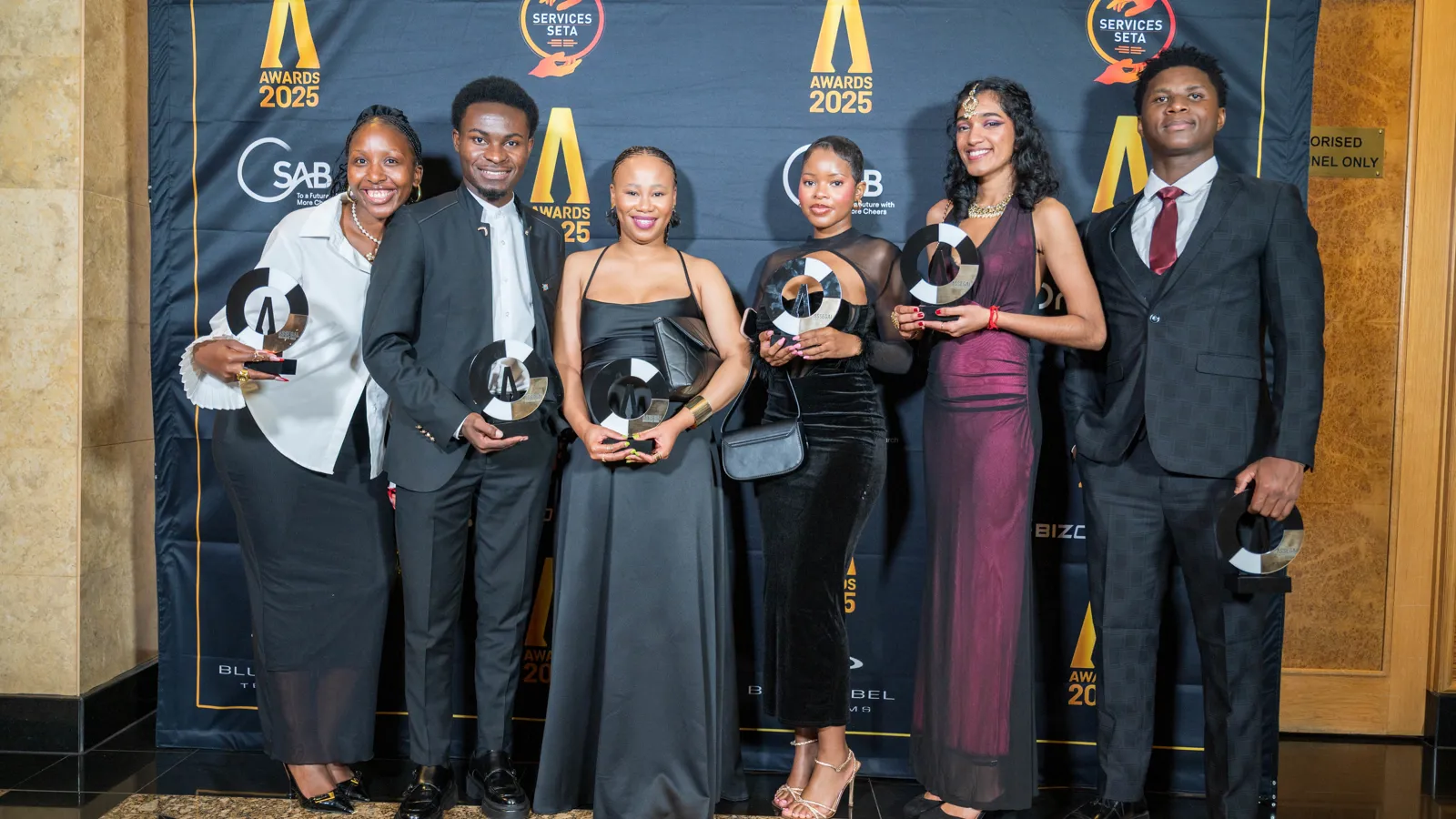Group of young award winners posing with trophies at the Assegai Awards 2025